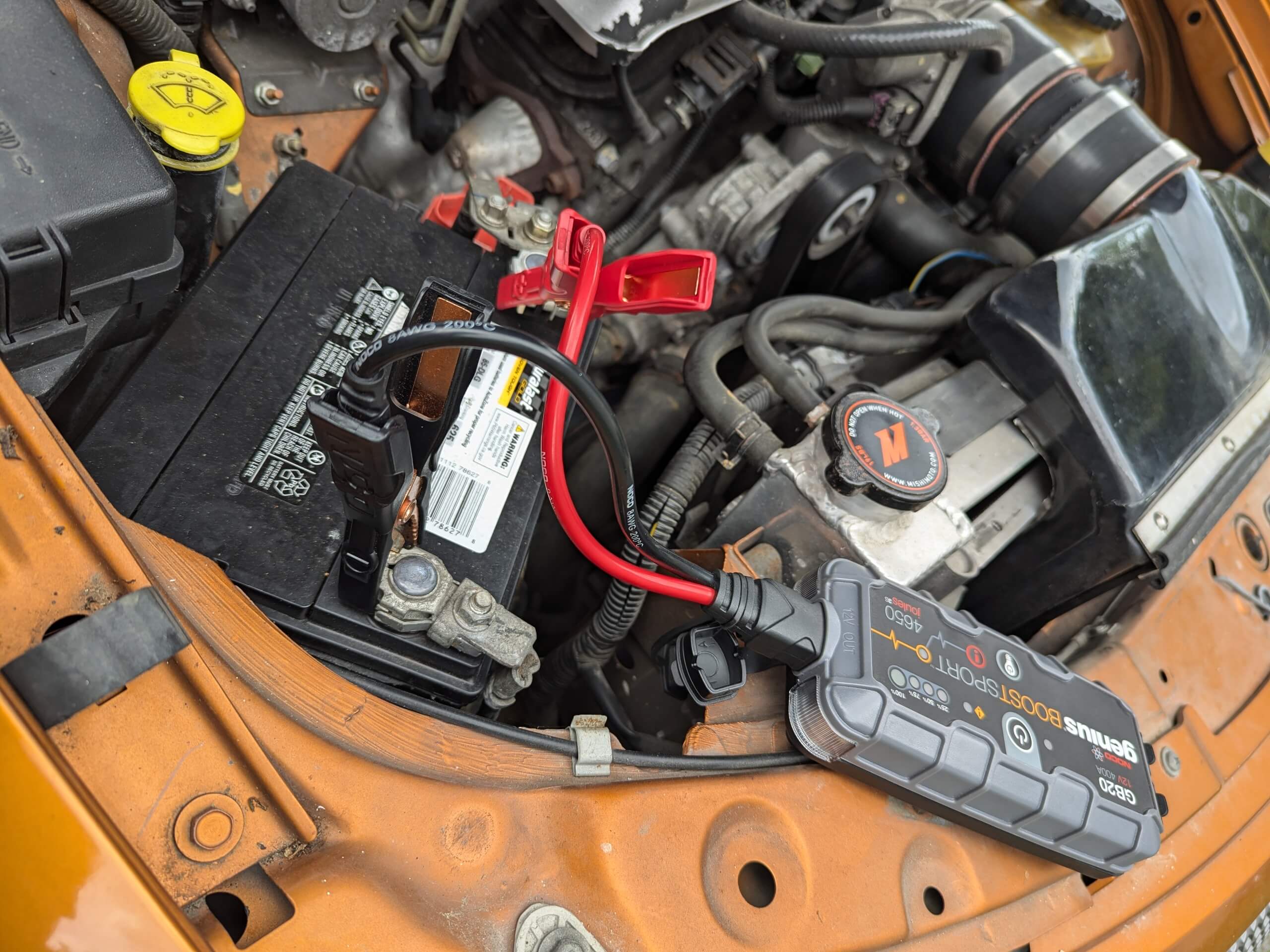 NOCO brand battery jump box in use.