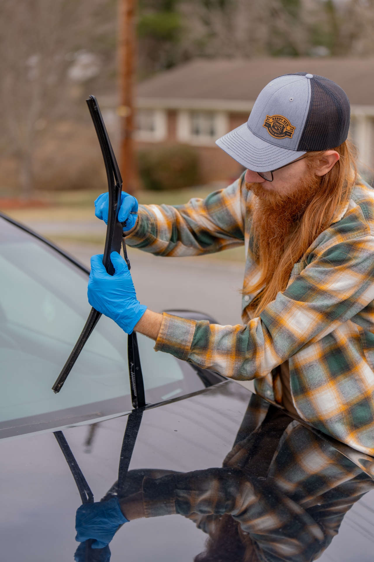 Handy Red removing a broken windshield wiper blade.